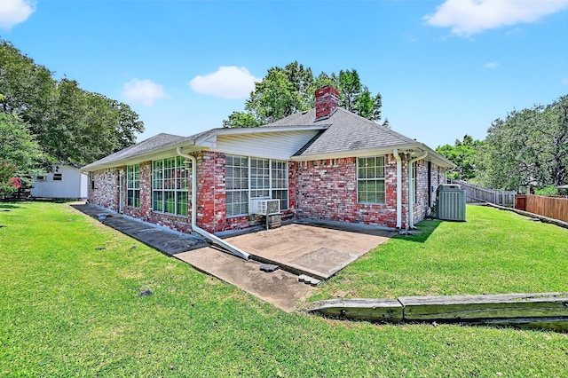2107 Meadows Cir, Sherman, TX 75092 - rear view of property featuring a patio area, a chimney, brick siding, and a shingled roof
