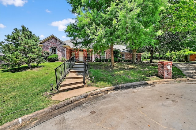 2107 Meadows Cir, Sherman, TX 75092 - view of property hidden behind natural elements featuring brick siding and a front lawn