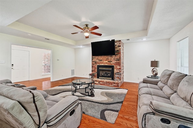 2107 Meadows Cir, Sherman, TX 75092 - living area featuring a ceiling fan, light wood finished floors, a brick fireplace, plenty of natural light, and recessed lighting