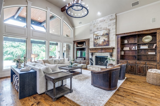 2521 Fair Oaks Ln, Prosper, TX 75078 - living area featuring wood finished floors, a fireplace, a chandelier, high vaulted ceiling, and ornamental molding