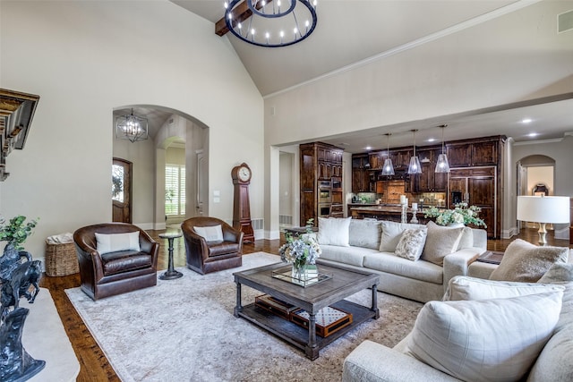 2521 Fair Oaks Ln, Prosper, TX 75078 - living room with arched walkways, a chandelier, wood finished floors, high vaulted ceiling, and crown molding