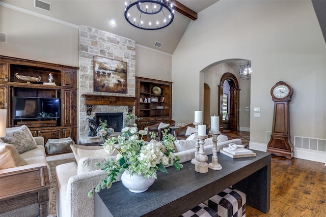 2521 Fair Oaks Ln, Prosper, TX 75078 - living area with arched walkways, high vaulted ceiling, wood finished floors, a stone fireplace, and beam ceiling