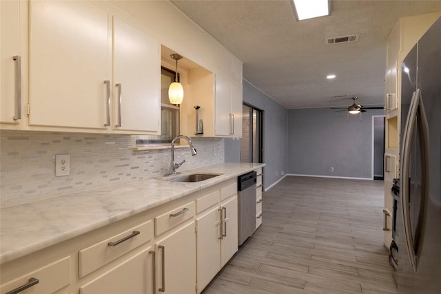 740 Willow St, Hurst, TX 76053 - kitchen with appliances with stainless steel finishes, tasteful backsplash, ceiling fan, white cabinets, and recessed lighting