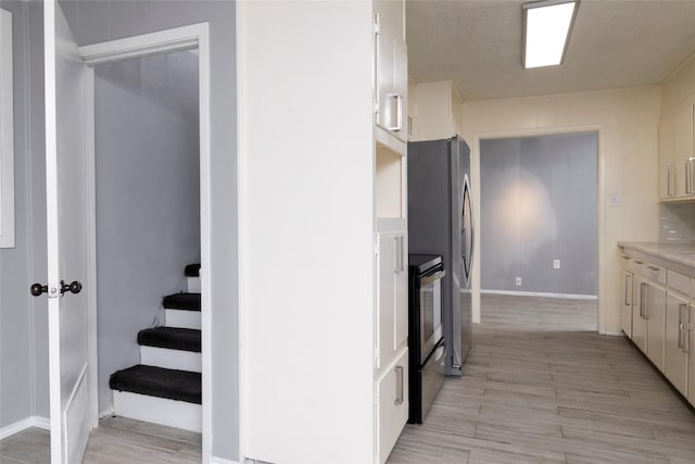 740 Willow St, Hurst, TX 76053 - kitchen with appliances with stainless steel finishes, light countertops, and light wood-style flooring