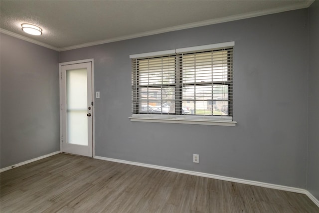 740 Willow St, Hurst, TX 76053 - unfurnished room featuring wood finished floors, crown molding, and a textured ceiling