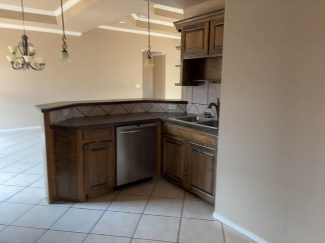 307 W Dormard Ave, Midland, TX 79705 - kitchen with stainless steel dishwasher, a raised ceiling, dark countertops, crown molding, and decorative backsplash