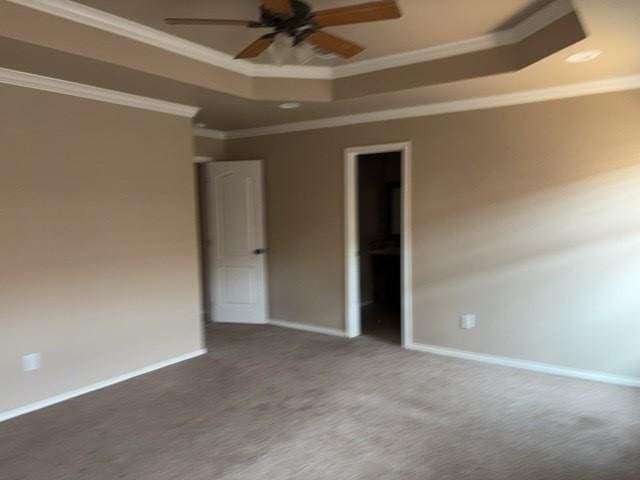 307 W Dormard Ave, Midland, TX 79705 - unfurnished bedroom with a tray ceiling, ornamental molding, and carpet