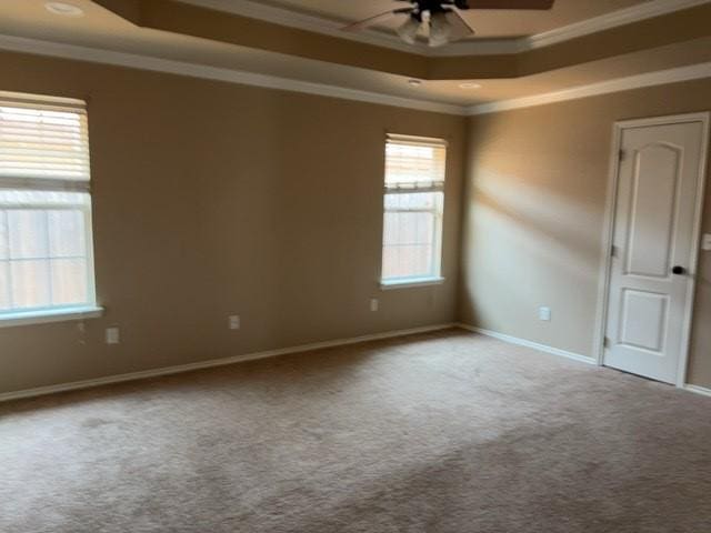 307 W Dormard Ave, Midland, TX 79705 - carpeted empty room featuring a raised ceiling, ceiling fan, and ornamental molding