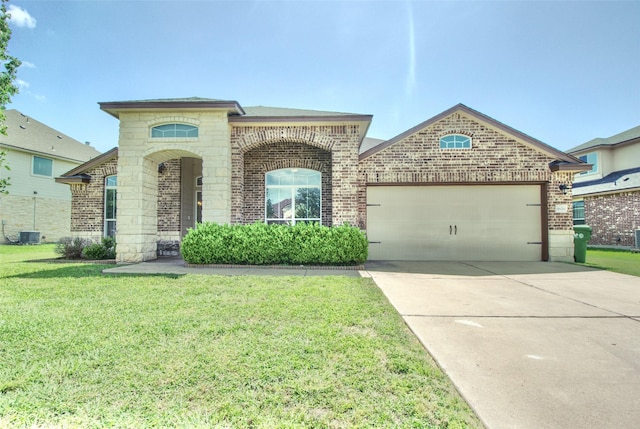 9929 Caney Creek Dr, Waco, TX 76708 - french provincial home featuring brick siding, a garage, a front yard, and driveway