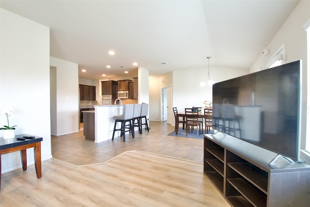 9929 Caney Creek Dr, Waco, TX 76708 - living area featuring vaulted ceiling, recessed lighting, light wood-style floors, and a chandelier