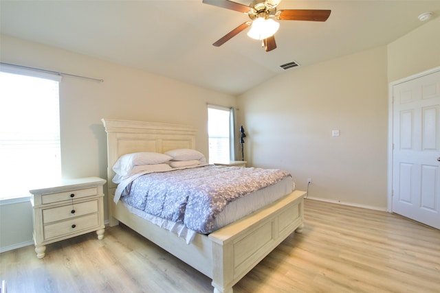 9929 Caney Creek Dr, Waco, TX 76708 - bedroom featuring light wood-style flooring, vaulted ceiling, multiple windows, and ceiling fan