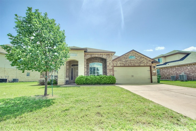 9929 Caney Creek Dr, Waco, TX 76708 - french country inspired facade featuring an attached garage, a front lawn, concrete driveway, brick siding, and stone siding