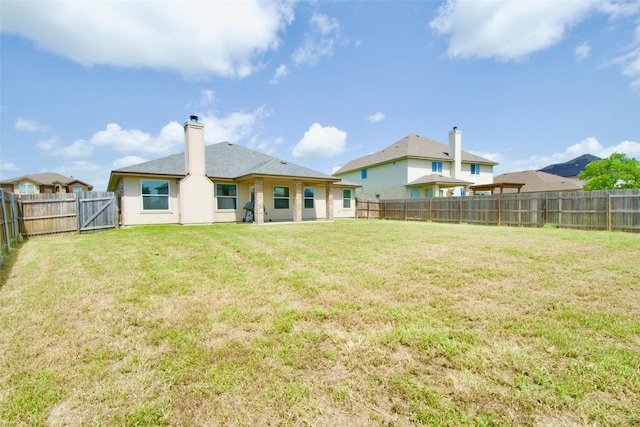 9929 Caney Creek Dr, Waco, TX 76708 - back of property with a fenced backyard and a chimney