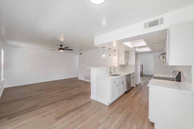 3509 Brook Glen Dr, Garland, TX 75044 - kitchen with range, stainless steel dishwasher, white cabinets, and light countertops