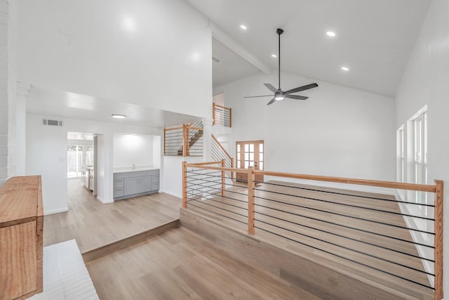 3509 Brook Glen Dr, Garland, TX 75044 - hallway featuring high vaulted ceiling, wood finished floors, healthy amount of natural light, recessed lighting, and beamed ceiling
