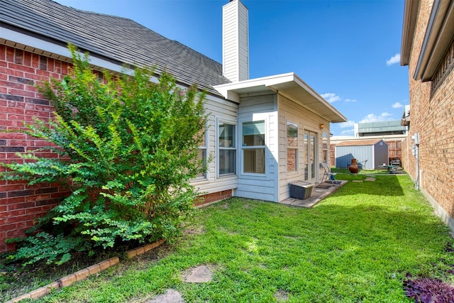 3104 Park Garden Pl, Richardson, TX 75082 - view of side of property featuring a lawn, a chimney, and a storage shed