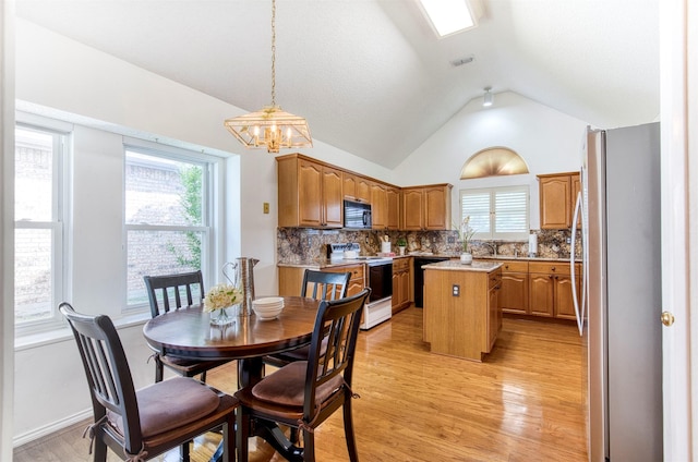 3104 Park Garden Pl, Richardson, TX 75082 - dining space featuring vaulted ceiling, light wood-style flooring, healthy amount of natural light, and a chandelier