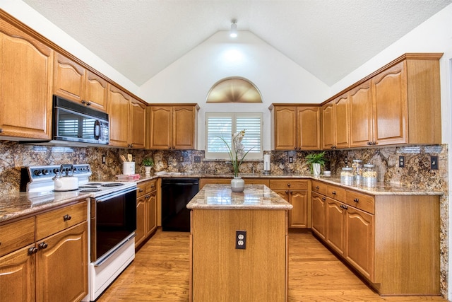3104 Park Garden Pl, Richardson, TX 75082 - kitchen with black appliances, a kitchen island, light wood-style floors, vaulted ceiling, and light stone countertops