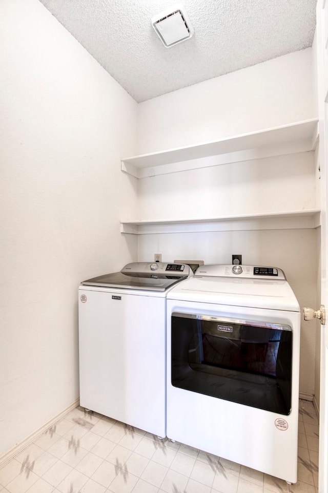 3104 Park Garden Pl, Richardson, TX 75082 - laundry room with washer and clothes dryer and a textured ceiling