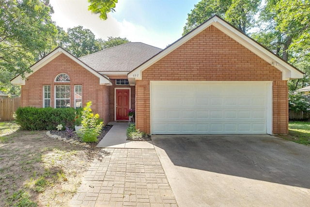 692 High Crest Dr, Azle, TX 76020 - view of front facade with concrete driveway, brick siding, an attached garage, and roof with shingles