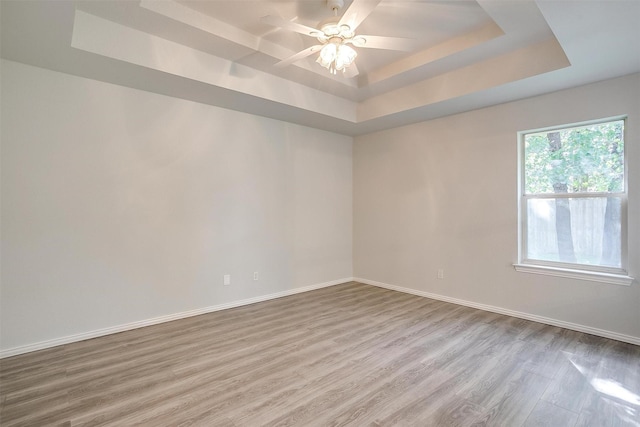 692 High Crest Dr, Azle, TX 76020 - spare room featuring a raised ceiling, wood finished floors, and ceiling fan