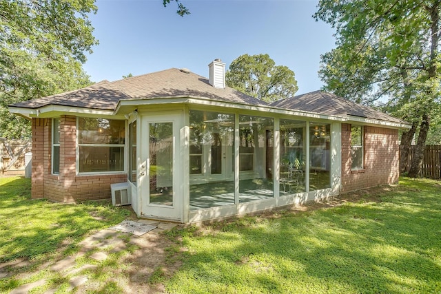 692 High Crest Dr, Azle, TX 76020 - view of property exterior featuring brick siding, a sunroom, a shingled roof, and a chimney