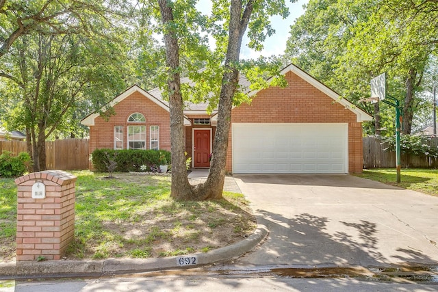 692 High Crest Dr, Azle, TX 76020 - view of front facade featuring driveway, an attached garage, and brick siding