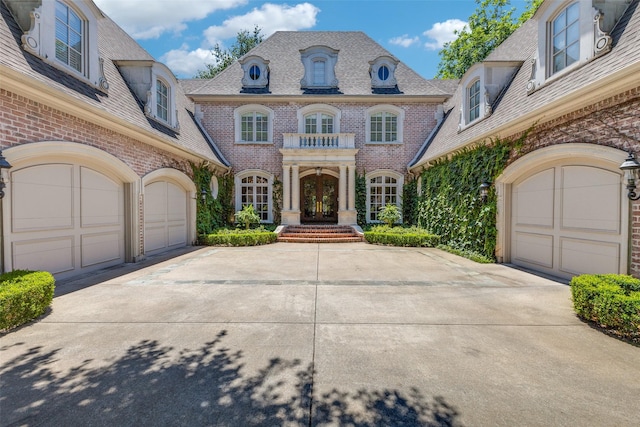 5930 Desco Dr, Dallas, TX 75225 - view of front of property featuring french doors, brick siding, driveway, and a garage