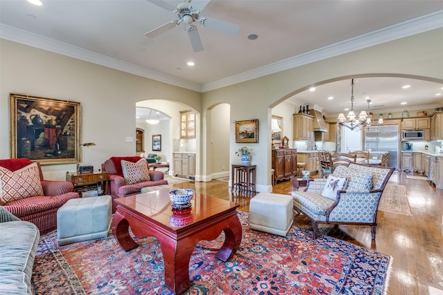 5930 Desco Dr, Dallas, TX 75225 - living room with arched walkways, light wood-type flooring, a ceiling fan, a chandelier, and ornamental molding