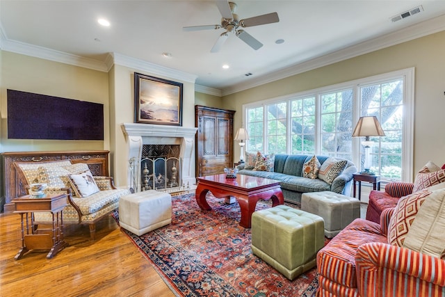 5930 Desco Dr, Dallas, TX 75225 - living area featuring wood finished floors, a ceiling fan, a fireplace with raised hearth, recessed lighting, and ornamental molding