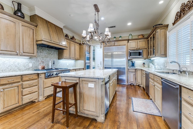 5930 Desco Dr, Dallas, TX 75225 - kitchen featuring built in appliances, a chandelier, an island with sink, crown molding, and light stone countertops