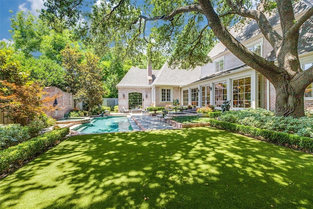 5930 Desco Dr, Dallas, TX 75225 - back of property featuring brick siding, a patio area, and a yard