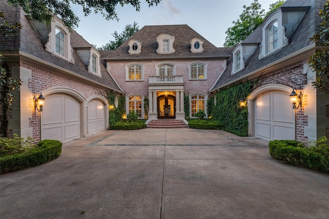 5930 Desco Dr, Dallas, TX 75225 - french country home with concrete driveway, french doors, a high end roof, and brick siding