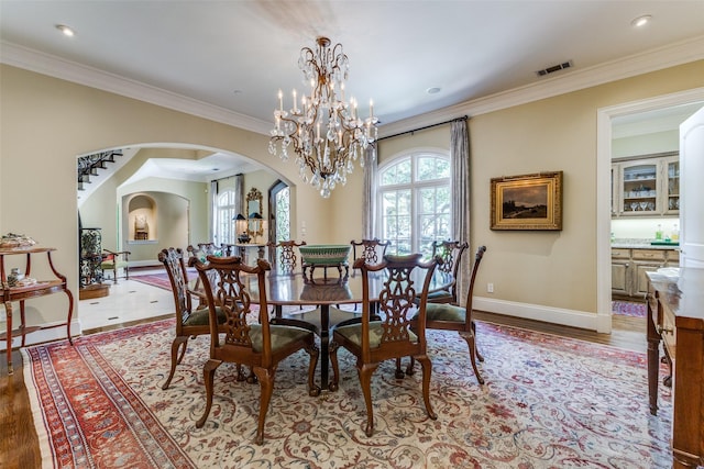 5930 Desco Dr, Dallas, TX 75225 - dining room with arched walkways, crown molding, a chandelier, wood finished floors, and recessed lighting