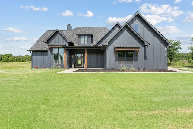 521 Echo Glade Ct, Azle, TX 76020 - view of front facade with a chimney, a front lawn, board and batten siding, and roof with shingles