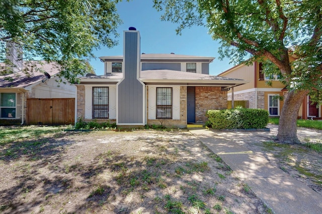 10320 Wood Heights Dr, Dallas, TX 75227 - view of front of home with a chimney and brick siding