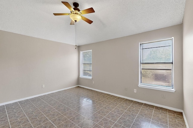 10320 Wood Heights Dr, Dallas, TX 75227 - tiled empty room with a textured ceiling and a ceiling fan