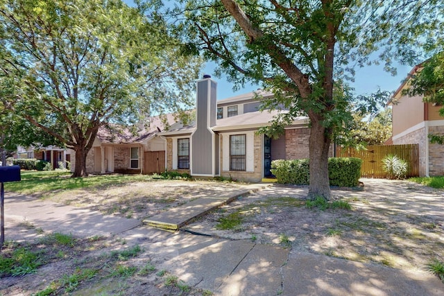10320 Wood Heights Dr, Dallas, TX 75227 - view of front of home featuring a chimney and brick siding