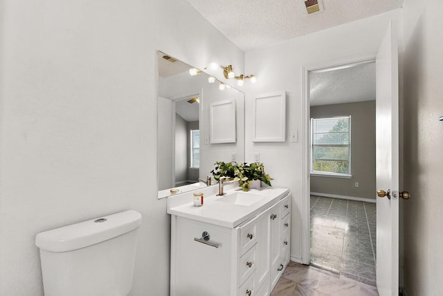 10320 Wood Heights Dr, Dallas, TX 75227 - half bathroom featuring marble finish floors, a textured ceiling, and vanity
