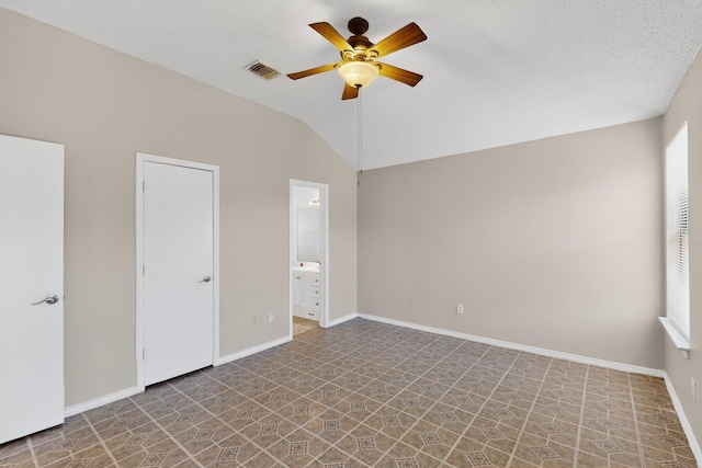 10320 Wood Heights Dr, Dallas, TX 75227 - unfurnished bedroom featuring lofted ceiling, connected bathroom, and a ceiling fan