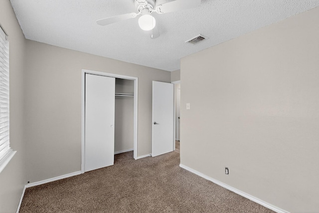 10320 Wood Heights Dr, Dallas, TX 75227 - unfurnished bedroom with carpet flooring, a closet, a ceiling fan, and a textured ceiling