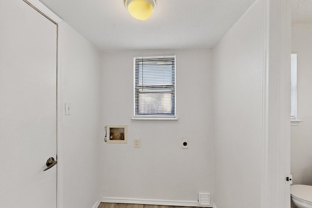 10320 Wood Heights Dr, Dallas, TX 75227 - laundry area with electric dryer hookup, washer hookup, and wood finished floors