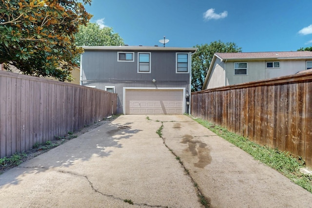 10320 Wood Heights Dr, Dallas, TX 75227 - rear view of house featuring driveway and a garage