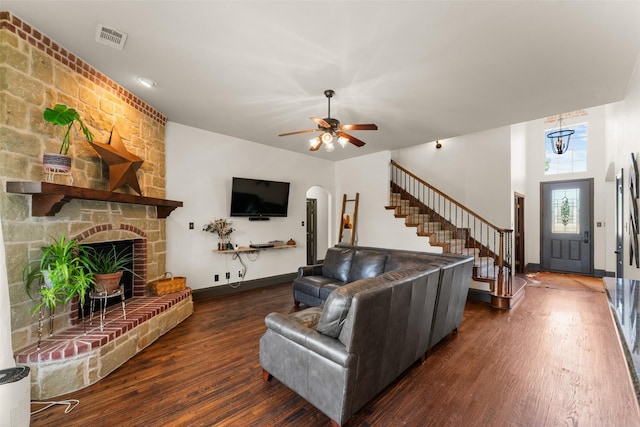 1740 Greenwood Ct, Prosper, TX 75078 - living area featuring wood finished floors, stairs, ceiling fan, a large fireplace, and arched walkways