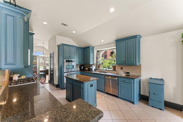 1740 Greenwood Ct, Prosper, TX 75078 - kitchen with stainless steel appliances, lofted ceiling, light tile patterned floors, dark stone countertops, and decorative backsplash