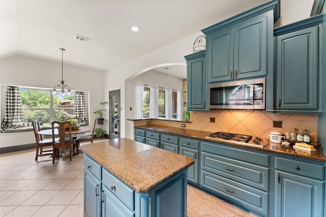1740 Greenwood Ct, Prosper, TX 75078 - kitchen with stainless steel appliances, healthy amount of natural light, a center island, arched walkways, and vaulted ceiling