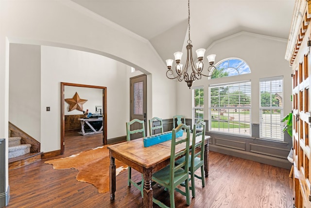 1740 Greenwood Ct, Prosper, TX 75078 - dining area with arched walkways, vaulted ceiling, a chandelier, crown molding, and wood finished floors