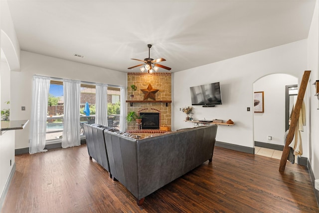 1740 Greenwood Ct, Prosper, TX 75078 - living room with arched walkways, a ceiling fan, dark wood finished floors, and a fireplace