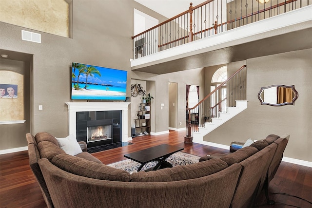 3217 Tearose Dr, Richardson, TX 75082 - living room with a high ceiling, wood finished floors, a fireplace, and stairs