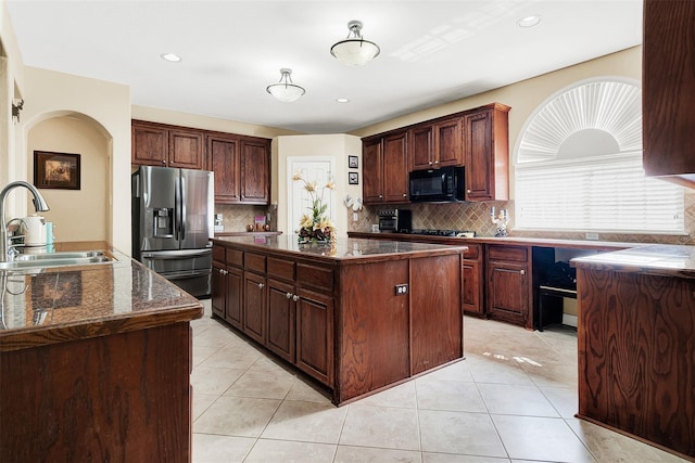 3217 Tearose Dr, Richardson, TX 75082 - kitchen with stainless steel fridge, black microwave, a center island, dark countertops, and tasteful backsplash